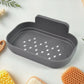 Durable plastic soap holder securely attached to a white tiled bathroom wall, ready for use.