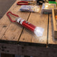Close-up view of the compact 4-in-1 laser pointer showing its LED light.