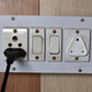 Image showing how to install a child safety outlet plug into a standard electrical socket.
