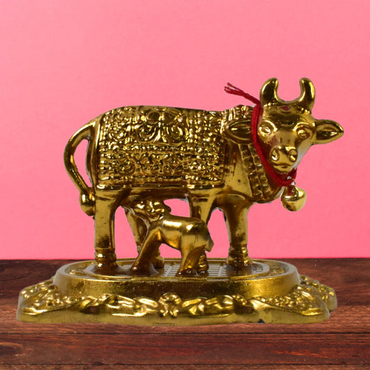 Sacred metal Kamdhenu Cow and calf idol in golden finish
