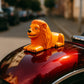 Orange-gold lion dashboard ornament enhancing car interior style