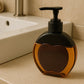 Side view of amber apple-shaped refillable liquid soap dispenser