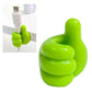 Green hand-shaped wall clip holder mounted on a wall holding cables