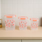 Stacked square floral airtight containers demonstrating space-saving design.