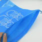 Hand holding the compact folded Organivo waterproof storage bag, emphasizing ease of carrying.