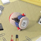 Pencil inserted into a cute cartoon pencil sharpener with eraser