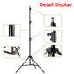 Artist setting up an adjustable metal easel for painting outdoors.
