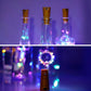 Cork style decorative bottle fairy lights glowing inside a clear glass bottle