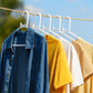 White plastic clothes hanger in practical use inside a closet