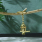 Intricate details of the golden Shivling metal keychain emphasizing religious symbolism