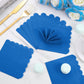 Folded royal blue scalloped paper napkin for elegant presentation