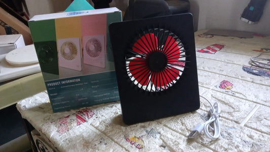 Side profile of the USB powered portable desk fan, demonstrating its small footprint on a desk.