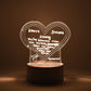 Workspace decorated with glowing 3D acrylic visualization lamp and drawing
