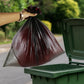 Garbage bag roll being easily dispensed from its compact packaging.