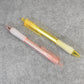 A pair of CustoPen ballpoint pens displayed with essential office stationery.