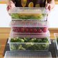 Clear plastic freezer storage container with a removable drain plate, ready for vegetables.