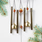 Lord Ganesh Wind Chimes displayed in garden setting creating peaceful ambiance