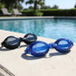 Pair of swimming goggles laid out on white background, highlighting design for clear underwater vision