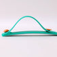 Phone grip strap in teal green used as a kickstand