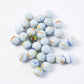 Set of heirloom style white glass marbles with colorful swirls