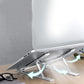 The durable metal portable laptop stand is shown with an open laptop on a clean desk.