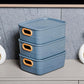 Three colorful plastic storage baskets with handle cutouts