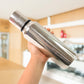 Close-up top view of stainless steel oil pourer showing wide mouth opening