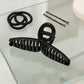 Back view of woman wearing hair claw clip holding elegant updo securely