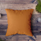 Multiple decorative pillow covers in various shades arranged on a couch.