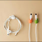 A mini utility hanger holding a small cloth, demonstrating its secure anti-slip hold.