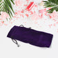 Stylish small fancy gift bag with its drawstring closure visible, ready for packaging.