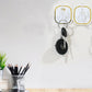 Transparent adhesive wall hook securely holding a heavy object, demonstrating its 3kg load capacity.