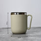 An Indian man enjoying a hot beverage from the Ganesh stainless steel coffee mug.