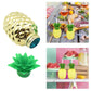 Decorative pineapple cup with straw amidst other colorful party decorations.