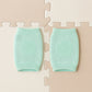 Close-up of soft mint green wool toddler knee protector leg warmers