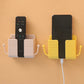Versatile wallmount mobile stand securely holding a phone and small accessories.