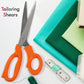 Tailor scissors with a yellow measuring tape showing both inches and centimeters for precise cutting.