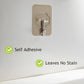 Close-up of reusable transparent wall hook adhesive for utility hanging