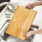Angled view of a sturdy wooden chopping board featuring an integrated holder.