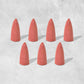 A pack of specialized backflow incense cones, essential for creating the smoke waterfall effect.