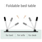 Individual using the portable bed desk for reading a book and taking notes in a relaxed setting.