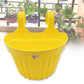 A set of durable hanging plastic planters in various colors for outdoor use.