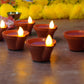 Multiple water sensor diyas scattered for a beautiful home decor.