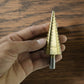 Detailed look at the sharp edges and titanium coating of the HSS steel step drill bits.
