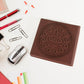 Top-down view of the chocolate scented notebook, emphasizing its compact size.