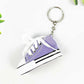 Miniature high-top basketball shoe keychain with black laces.