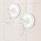 Four plastic suction cup hooks arranged for hanging items