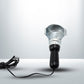 The Portable Work Lamp placed on a surface, highlighting its stable base.