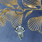 Side angle view of silver Trishul Damru keychain highlighting craftsmanship