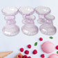 Clear plastic serving bowls displayed with various fruits and snacks.